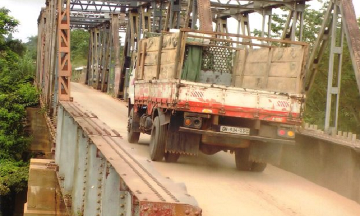 Some vehicles using the weak bridge which was closed to vehicular traffic. Pictures: Samuel Kyei -Boateng